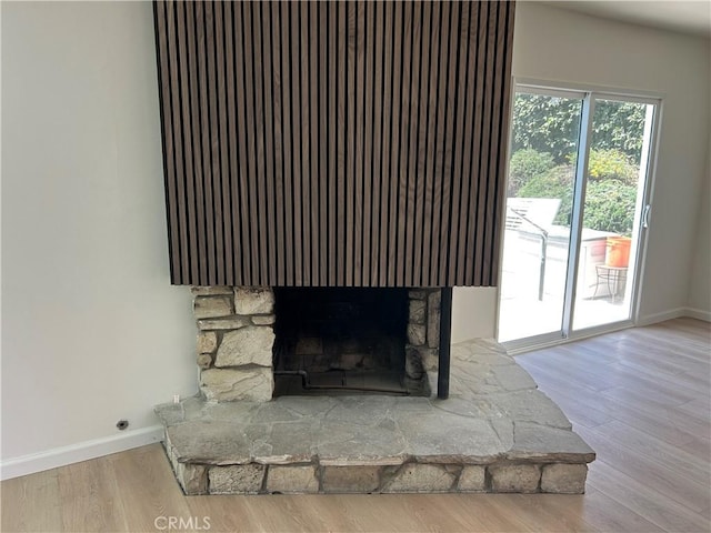 990 244th St, Harbor City, CA 90710 - detailed view of baseboards, wood finished floors, and a stone fireplace