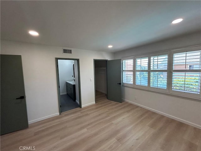 990 244th St, Harbor City, CA 90710 - unfurnished bedroom featuring light wood finished floors, baseboards, recessed lighting, ensuite bathroom, and a closet