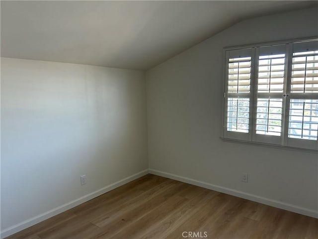 990 244th St, Harbor City, CA 90710 - additional living space with wood finished floors, vaulted ceiling, and baseboards