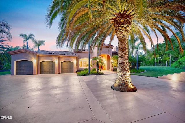 1690 Calle Tierra Vis, Camarillo, CA 93010 - mediterranean / spanish-style house featuring curved driveway, stucco siding, a tile roof, a garage, and a front yard