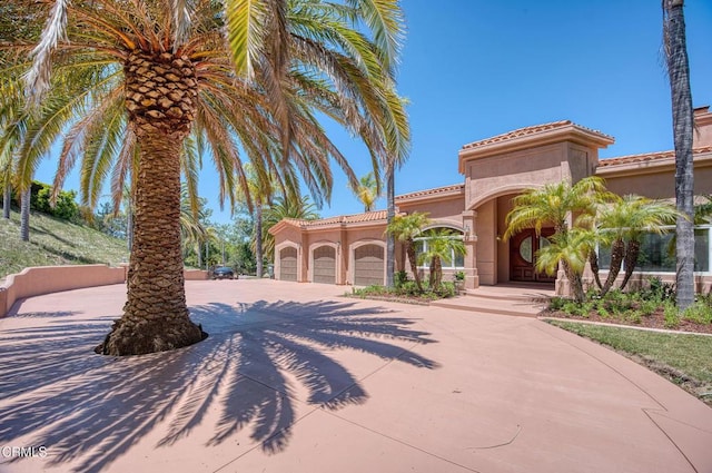 1690 Calle Tierra Vis, Camarillo, CA 93010 - mediterranean / spanish-style home with stucco siding, a garage, driveway, and a tiled roof