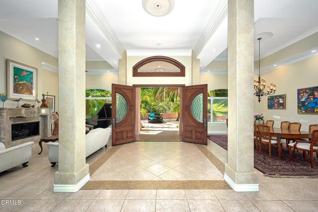 1690 Calle Tierra Vis, Camarillo, CA 93010 - entrance foyer featuring ornamental molding, decorative columns, a chandelier, tile patterned flooring, and a fireplace