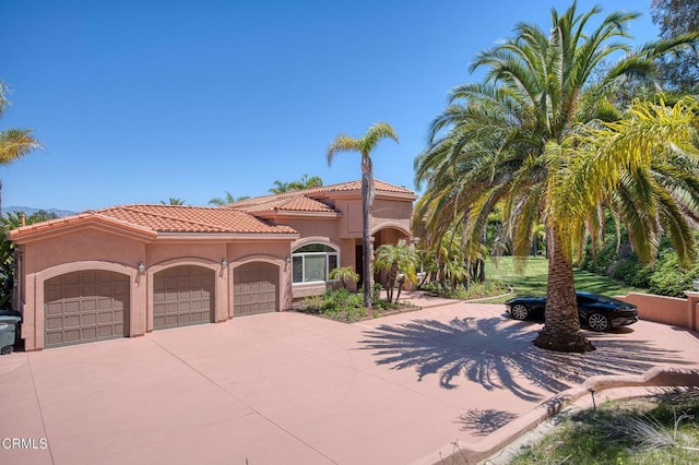 1690 Calle Tierra Vis, Camarillo, CA 93010 - mediterranean / spanish home with an attached garage, concrete driveway, stucco siding, and a tiled roof