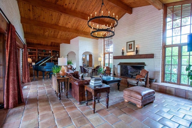 11105 Berry Rd, Valley Center, CA 92082 - living area featuring a fireplace, a wood ceiling with exposed beams, high vaulted ceiling, and a chandelier