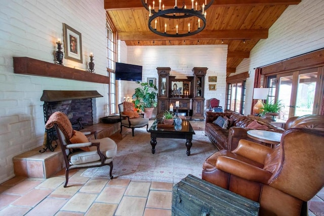 11105 Berry Rd, Valley Center, CA 92082 - living area with a chandelier, a wood ceiling with exposed beams, a stone fireplace, high vaulted ceiling, and french doors