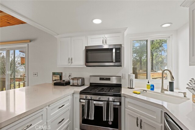 1803 Nob Hill Dr, Running Springs, CA 92382 - kitchen with appliances with stainless steel finishes, a sink, plenty of natural light, white cabinetry, and recessed lighting