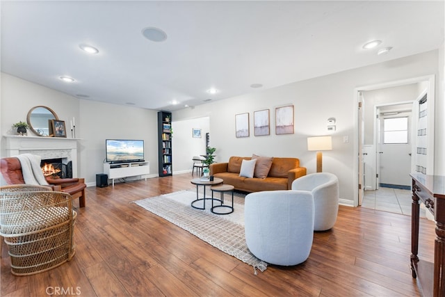 1121 E 1st St, Tustin, CA 92780 - living room with a lit fireplace, hardwood / wood-style flooring, recessed lighting, and baseboards