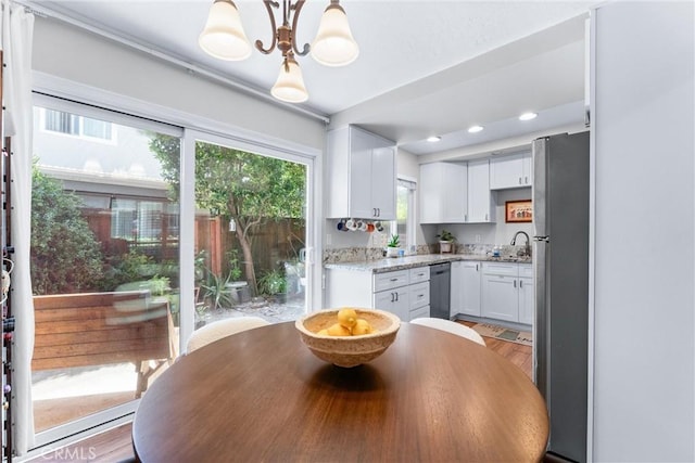 1121 E 1st St, Tustin, CA 92780 - dining room with a chandelier, light wood finished floors, and recessed lighting