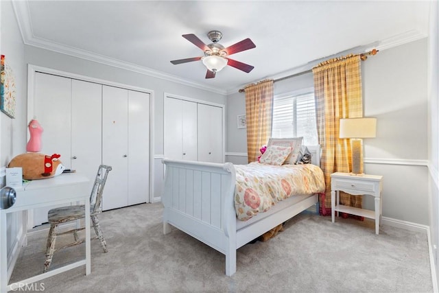 1121 E 1st St, Tustin, CA 92780 - bedroom featuring two closets, light colored carpet, a desk, ornamental molding, and a ceiling fan