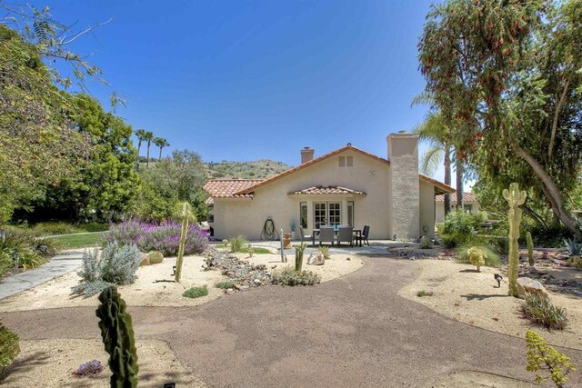 3749 Sarah Ann Dr, Fallbrook, CA 92028 - mediterranean / spanish-style house with a patio area, a tiled roof, stucco siding, and a chimney