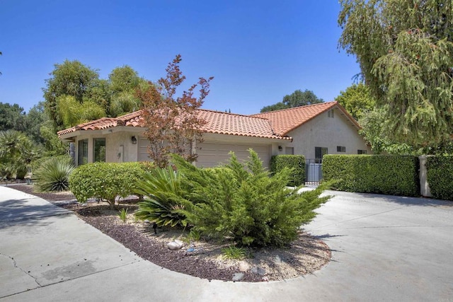 3749 Sarah Ann Dr, Fallbrook, CA 92028 - view of side of home featuring an attached garage, a tiled roof, stucco siding, and fence