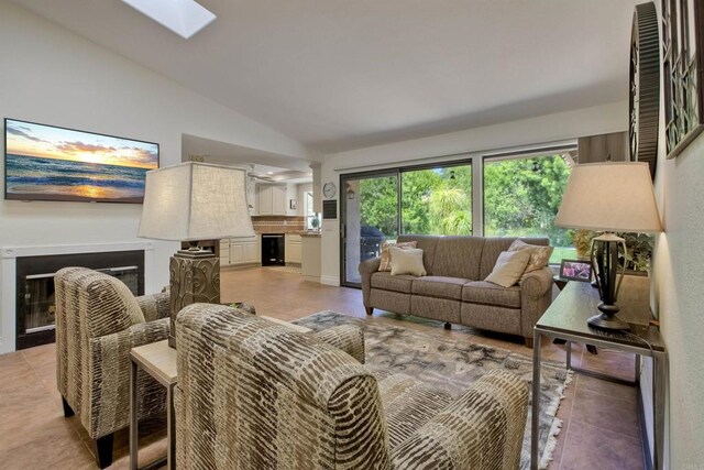 3749 Sarah Ann Dr, Fallbrook, CA 92028 - living area featuring lofted ceiling, a skylight, and a glass covered fireplace
