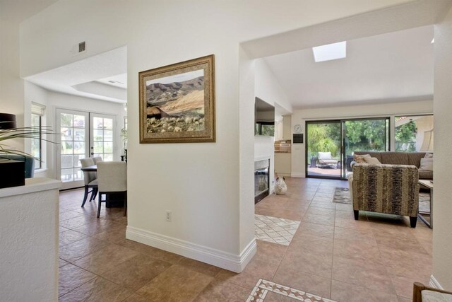 3749 Sarah Ann Dr, Fallbrook, CA 92028 - hallway with baseboards, a skylight, light tile patterned floors, and vaulted ceiling