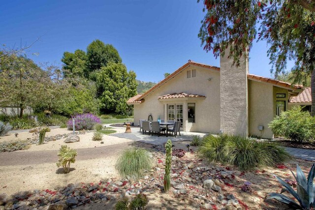 3749 Sarah Ann Dr, Fallbrook, CA 92028 - rear view of house featuring stucco siding, a patio, a tiled roof, and a chimney
