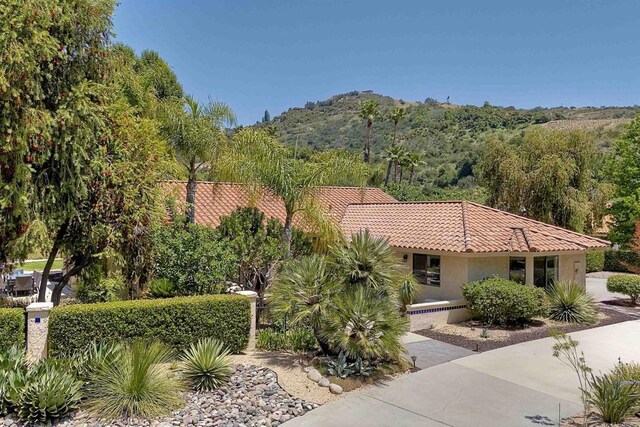 3749 Sarah Ann Dr, Fallbrook, CA 92028 - view of front of house featuring a tiled roof, stucco siding, and a mountain view