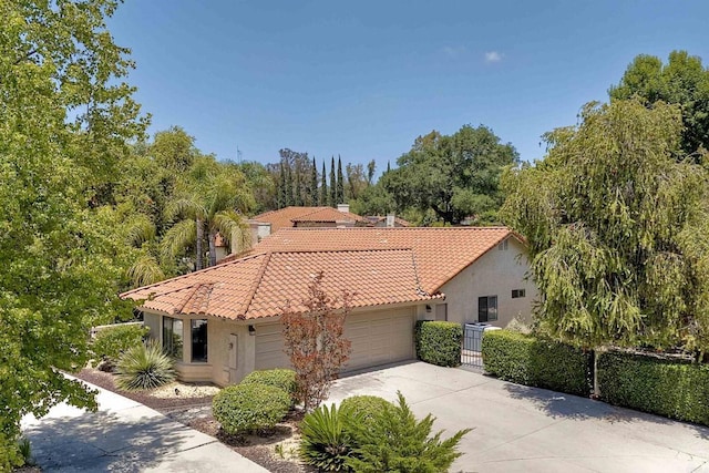 3749 Sarah Ann Dr, Fallbrook, CA 92028 - mediterranean / spanish home with a tile roof, stucco siding, concrete driveway, an attached garage, and fence
