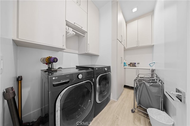 1270 W Chase Dr, Corona, CA 92882 - laundry room with light wood-type flooring, washer and clothes dryer, and cabinet space