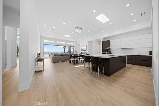 1270 W Chase Dr, Corona, CA 92882 - kitchen with modern cabinets, a sink, a large island with sink, light countertops, and open floor plan