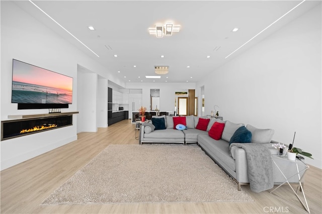 1270 W Chase Dr, Corona, CA 92882 - living room featuring light wood-type flooring, recessed lighting, and a glass covered fireplace