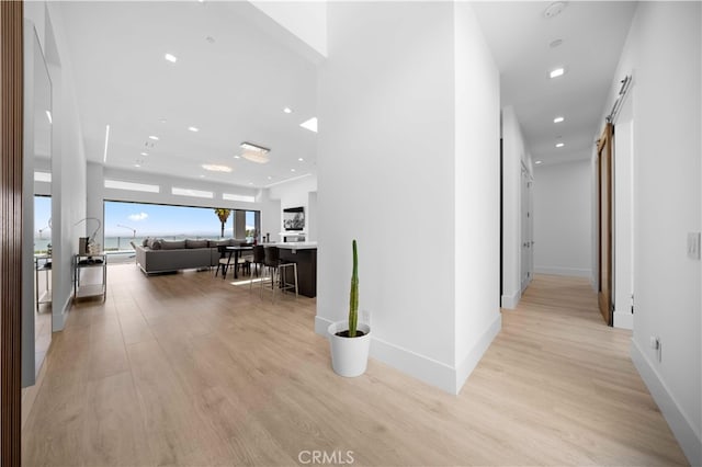 1270 W Chase Dr, Corona, CA 92882 - hall with a barn door, light wood-style floors, recessed lighting, and baseboards
