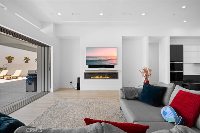 1270 W Chase Dr, Corona, CA 92882 - living room featuring a glass covered fireplace, wood finished floors, recessed lighting, and baseboards