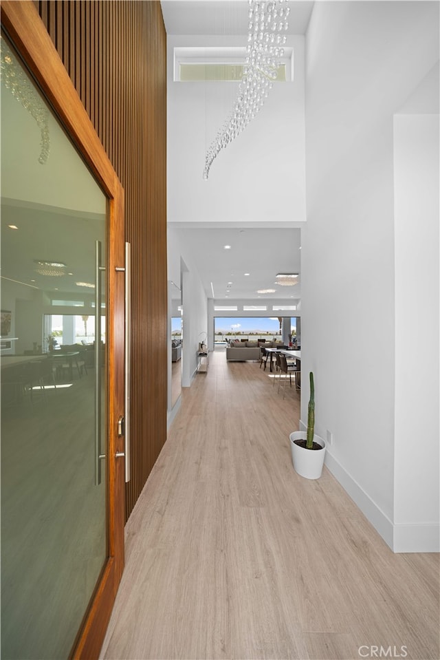 1270 W Chase Dr, Corona, CA 92882 - corridor with a towering ceiling, wood finished floors, and baseboards