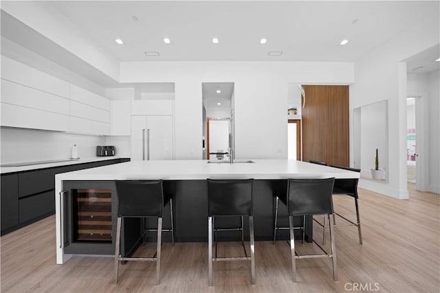 1270 W Chase Dr, Corona, CA 92882 - kitchen featuring modern cabinets, beverage cooler, light countertops, and recessed lighting