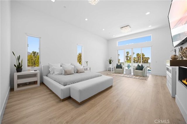 1270 W Chase Dr, Corona, CA 92882 - bedroom featuring a high ceiling, a glass covered fireplace, access to outside, light wood-type flooring, and recessed lighting