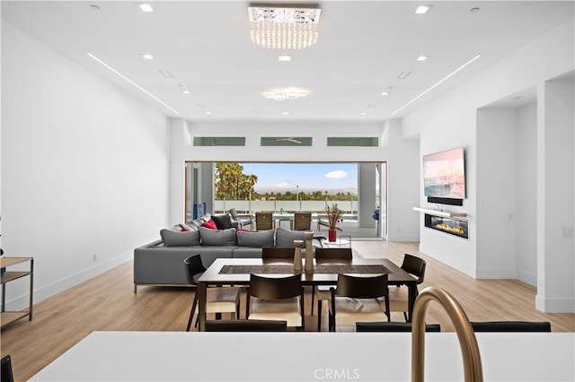 1270 W Chase Dr, Corona, CA 92882 - dining room featuring light wood-type flooring, a glass covered fireplace, baseboards, and recessed lighting