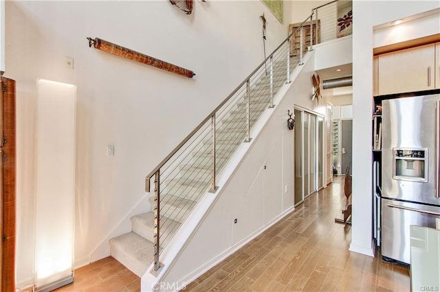 133 The Promenade N Unit 408, Long Beach, CA 90802 - staircase with wood finished floors and a high ceiling
