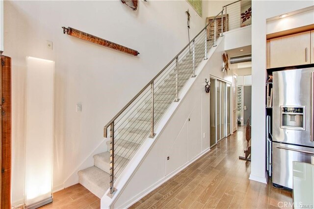 133 The Promenade N Unit 408, Long Beach, CA 90802 - stairway with wood finished floors and a towering ceiling