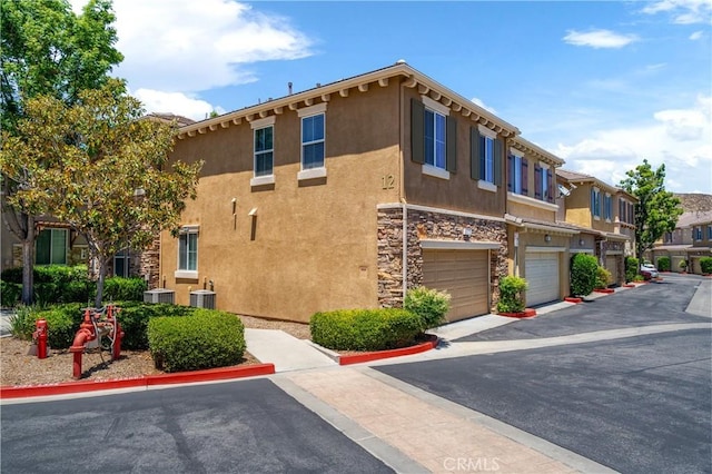 30505 Canyon Hills Rd Unit 1205, Lake Elsinore, CA 92532 - view of building exterior with an attached garage, central air condition unit, and a residential view