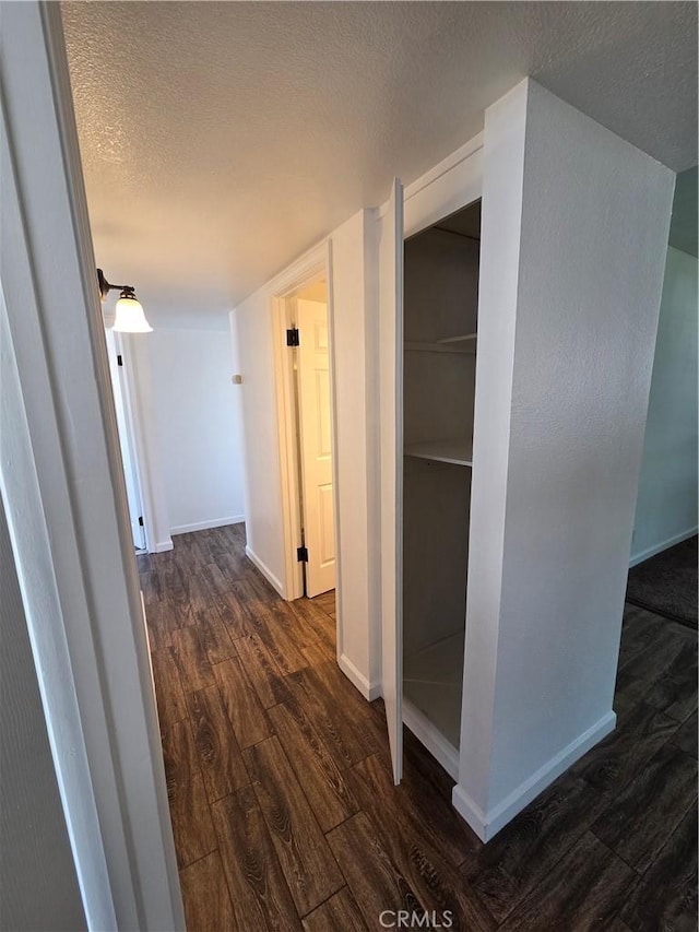 355 Woodlark St, Lancaster, CA 93535 - hall featuring dark wood finished floors, a textured ceiling, and baseboards