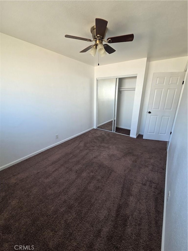 355 Woodlark St, Lancaster, CA 93535 - unfurnished bedroom with dark carpet, a closet, baseboards, and a ceiling fan