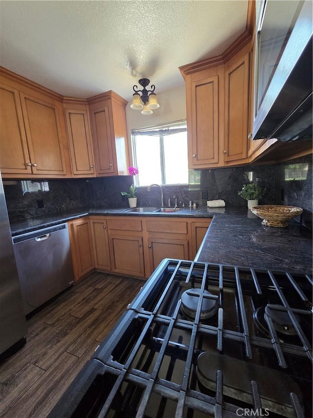 355 Woodlark St, Lancaster, CA 93535 - kitchen featuring a sink, dark wood-style flooring, dishwasher, backsplash, and a textured ceiling
