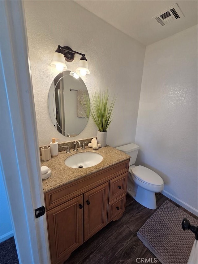 355 Woodlark St, Lancaster, CA 93535 - half bath featuring vanity, toilet, wood finished floors, and baseboards