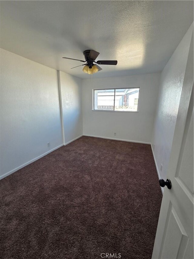 355 Woodlark St, Lancaster, CA 93535 - unfurnished room with dark colored carpet, ceiling fan, and baseboards