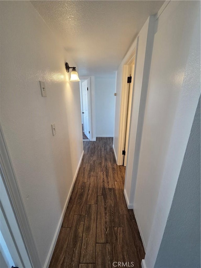 355 Woodlark St, Lancaster, CA 93535 - hallway featuring dark wood-style floors, baseboards, and a textured ceiling