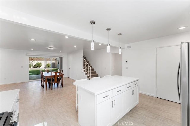 13421 Epping Way, Tustin, CA 92780 - kitchen featuring freestanding refrigerator, open floor plan, white cabinetry, recessed lighting, and pendant lighting