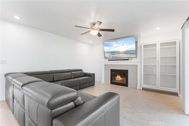13421 Epping Way, Tustin, CA 92780 - living area with ceiling fan, light tile patterned floors, a brick fireplace, recessed lighting, and baseboards