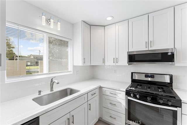 13421 Epping Way, Tustin, CA 92780 - kitchen with appliances with stainless steel finishes, a sink, white cabinetry, tasteful backsplash, and recessed lighting