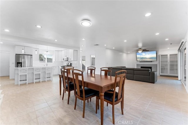 13421 Epping Way, Tustin, CA 92780 - dining space featuring ceiling fan, a fireplace, light tile patterned floors, and recessed lighting
