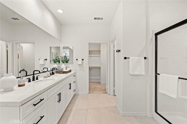 937 E Wonder Ln, Glendora, CA 91740 - full bathroom featuring a shower stall, double vanity, a spacious closet, baseboards, and tile patterned flooring