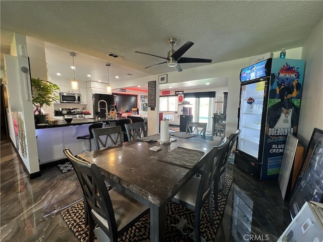 15245 Apache Rd, Apple Valley, CA 92307 - dining space featuring ceiling fan and a textured ceiling