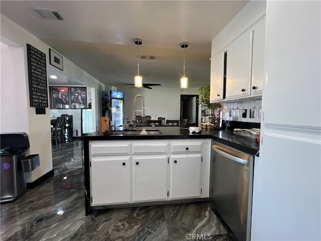 15245 Apache Rd, Apple Valley, CA 92307 - kitchen with stainless steel dishwasher, a peninsula, dark marble finish flooring, dark countertops, and white cabinetry