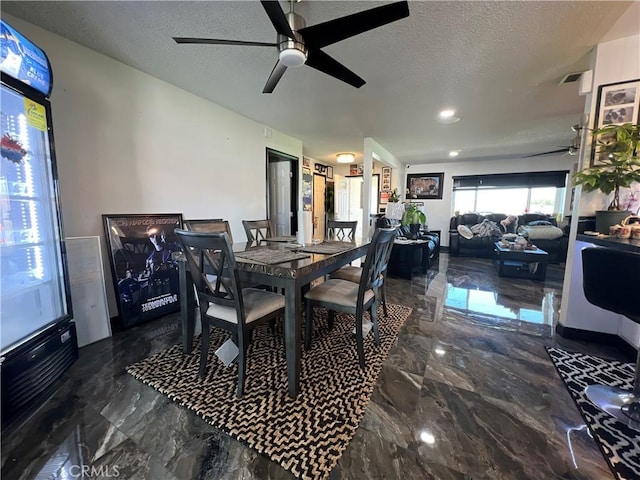 15245 Apache Rd, Apple Valley, CA 92307 - dining room with marble tiled floors, ceiling fan, and a textured ceiling