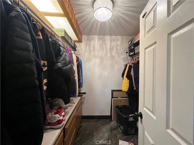 15245 Apache Rd, Apple Valley, CA 92307 - walk in closet featuring a chandelier and marble look tiles