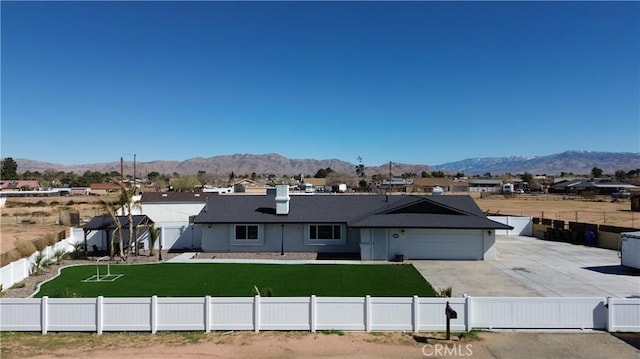 15245 Apache Rd, Apple Valley, CA 92307 - view of front of house featuring a mountain view, an attached garage, and a residential view