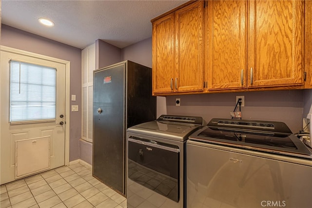43156 41st St W, Lancaster, CA 93536 - laundry room featuring cabinet space, independent washer and dryer, light tile patterned floors, a textured ceiling, and baseboards