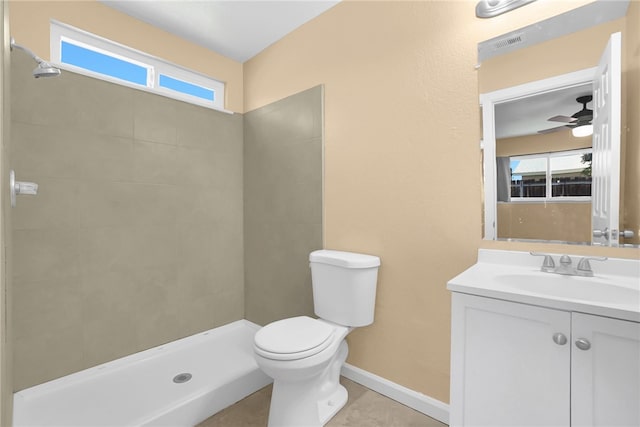 1018 N Millard Ave, Rialto, CA 92376 - full bathroom featuring vanity, a tile shower, toilet, baseboards, and a ceiling fan